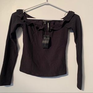 Black off the shoulder top with ruffled neckline.
